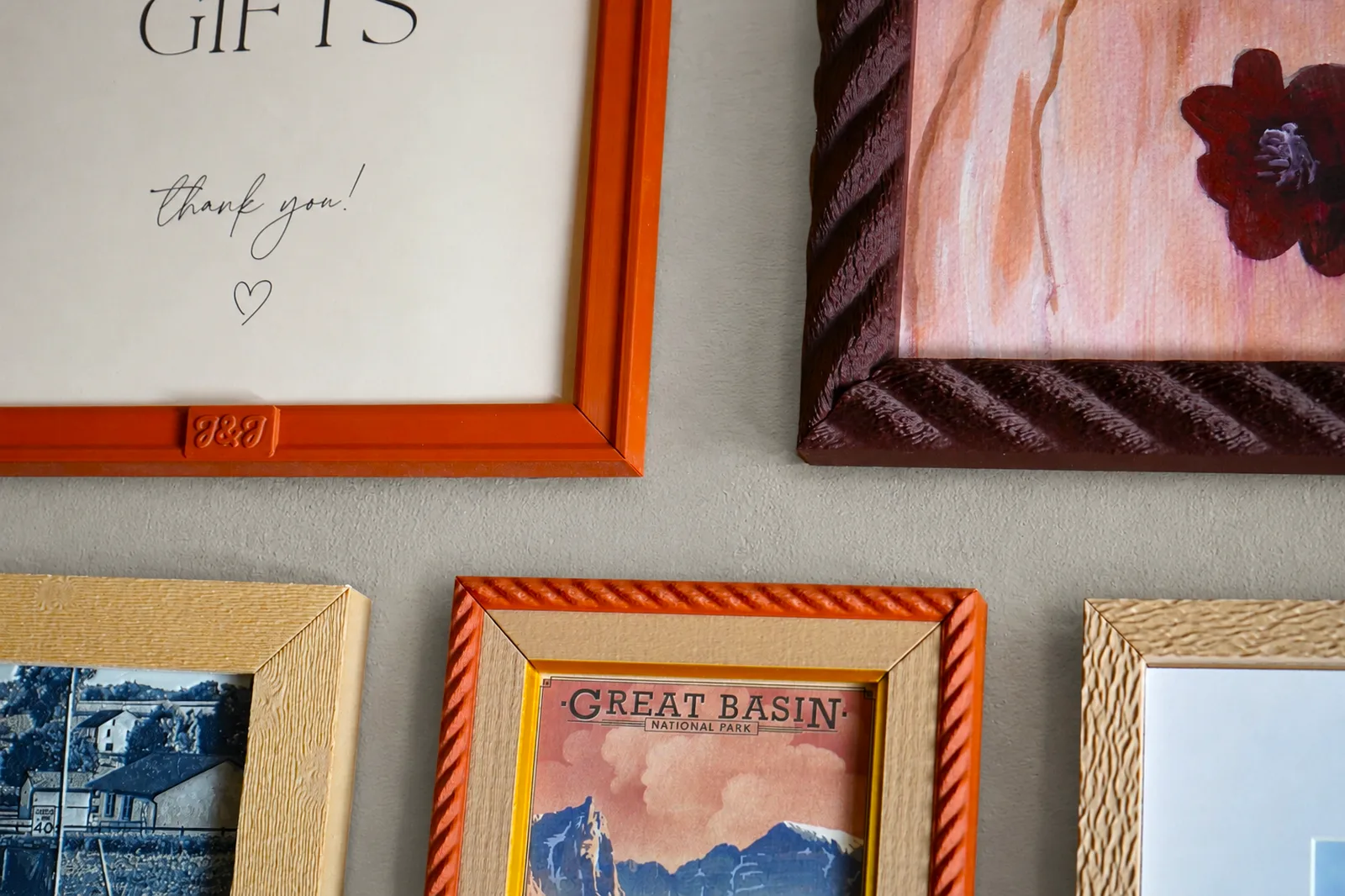 Wall of custom 3D printed picture frames made with SnapFrames