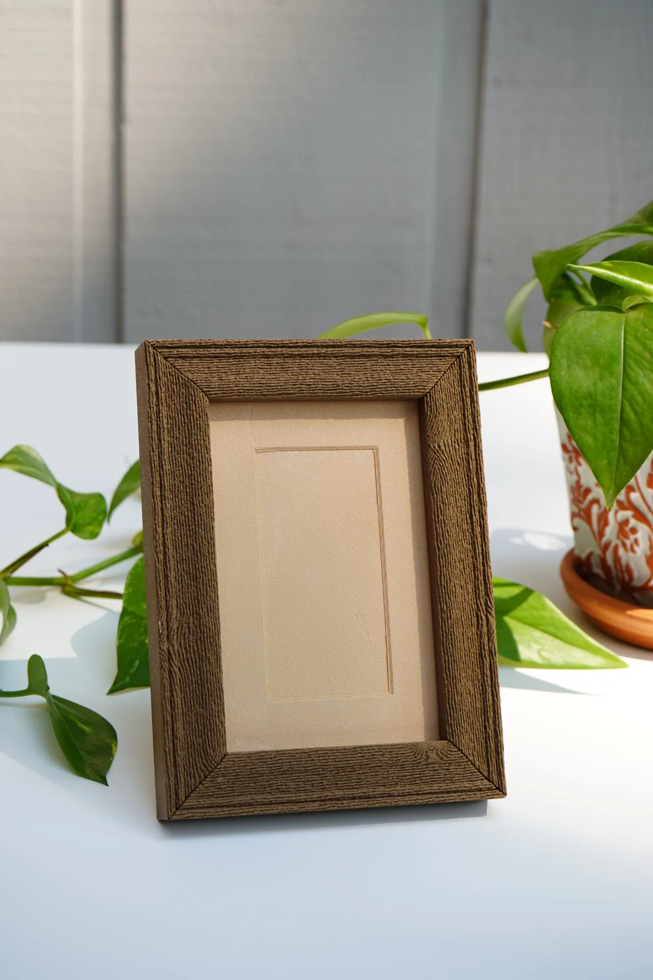 A wood grain frame with a printed mat